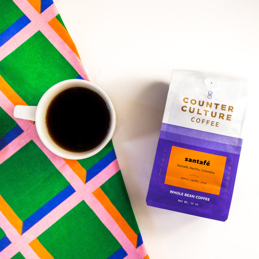 Top down photo of a bag of Santafé coffee and a mug of coffee.