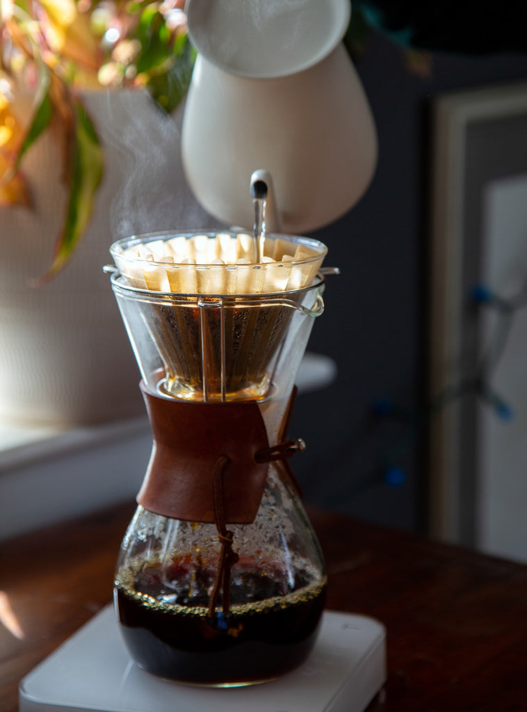 Photo of water being poured from a kettle into a chemex.