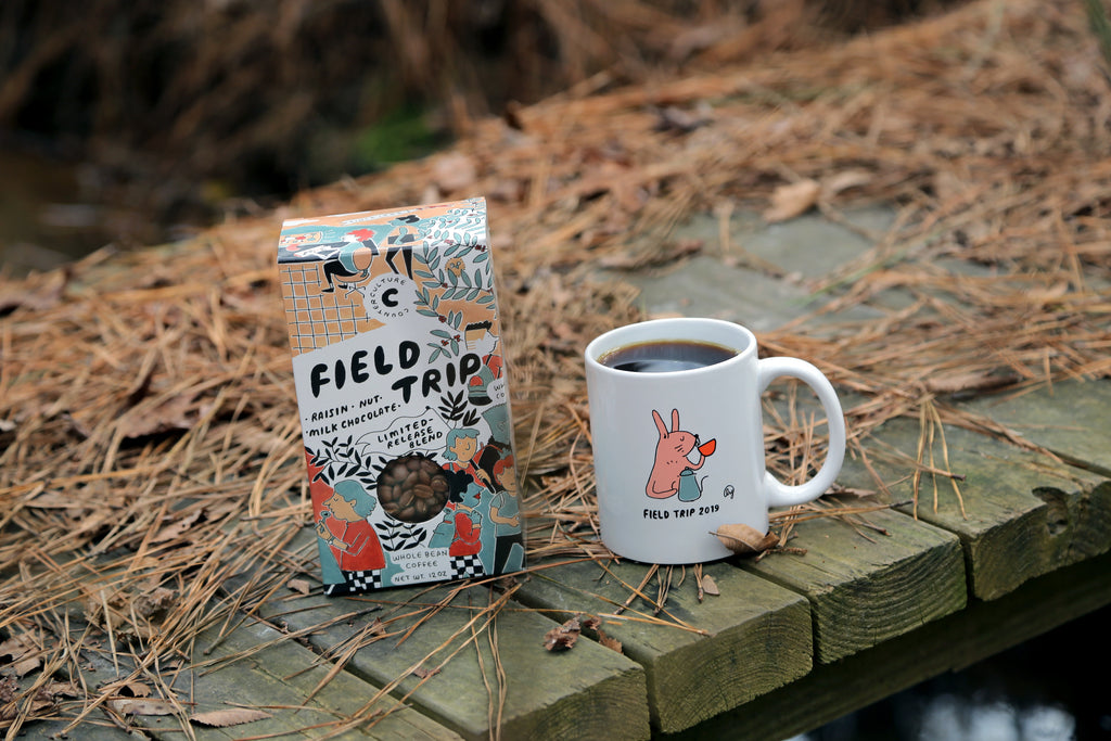Photo of a box of Field Trip coffee next to a mug full of coffee.