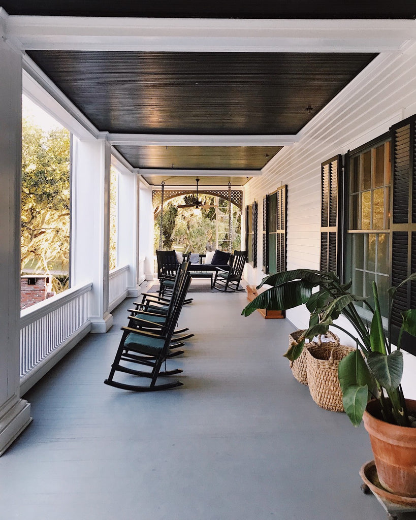 Photo of the porch at Greyfield Inn with rocking chairs on it. 