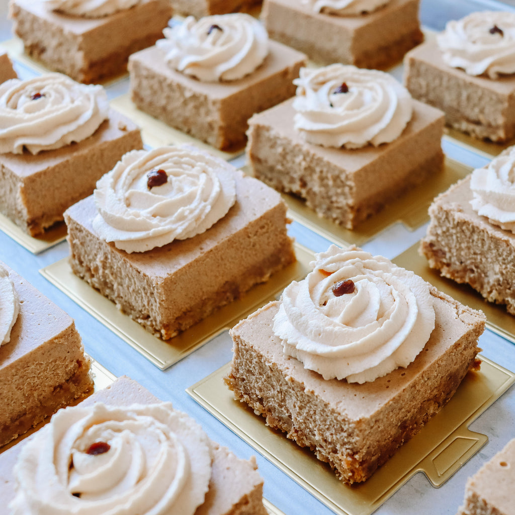 Photo of small cinnamon cheesecake on gold foil all laid out in lines.