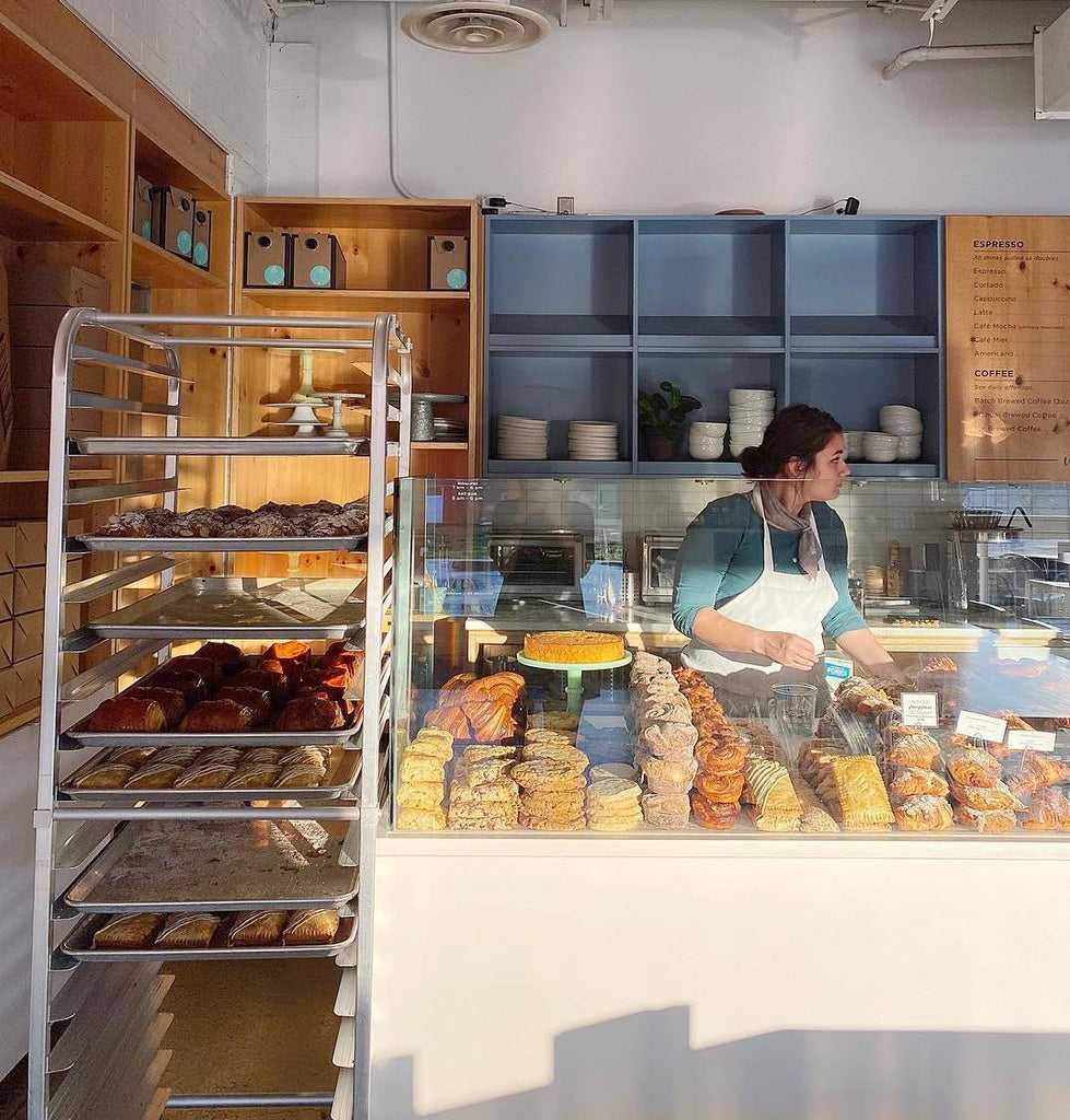 Photo of a person behind the pasty display at Wild Love Bakehouse.