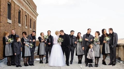 group of women in dirndls with semi sweetheart neckline and men in suits, with a woman in the middle wearing a bridal dirndl