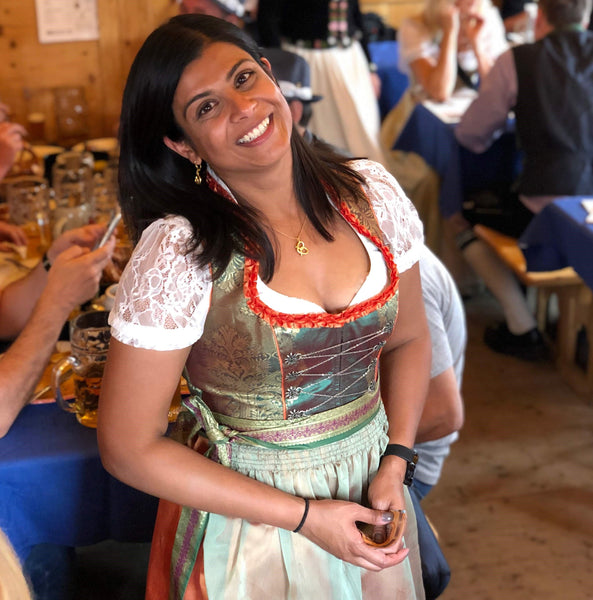 woman at oktoberfest wearing german style clothing and a while puff sleeves dirndl blouse