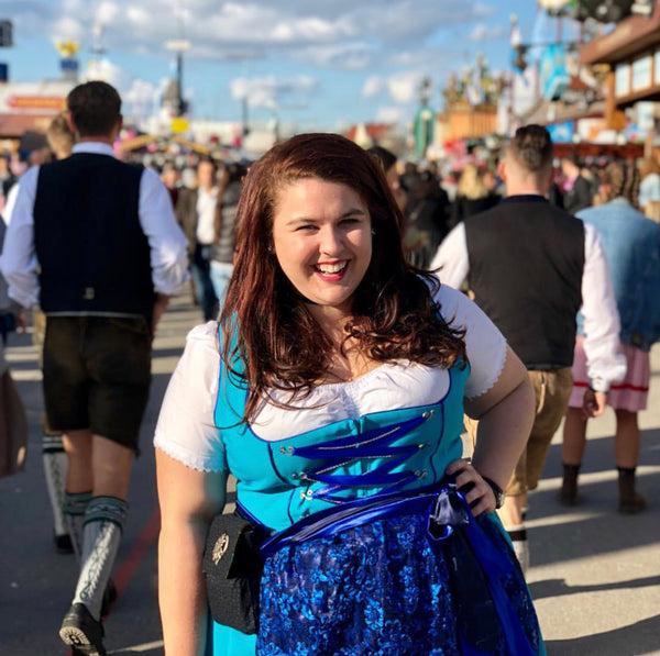 woman smiling and wearing a dirndl dress plus size