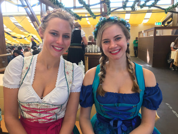 two women wearing dirndl germany with dirndl blouses and flower crowns in a beer tent