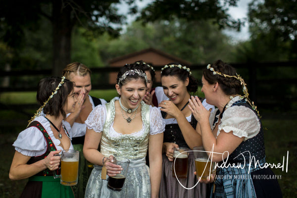 group of woman laughing wearing traditional women's german clothing at a wedding