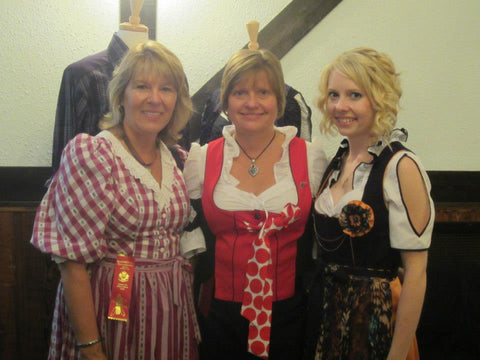 Three women in traditional german attire celebrating german heritage