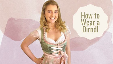 girl in a green and pink dirndl with a cap sleeve dirndl blouse with a pink background