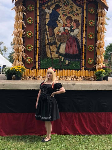 image of a woman wearing an all black dirndl at a volksfest in germany