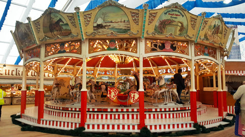 a ivory and red carousel inside one of the oktoberfest tents.