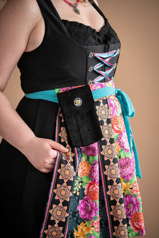 image of a black dirndl with floral apron and an apron purse attached