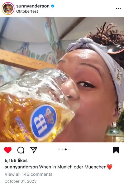 Food Network star, Sunny Anderson drinking a liter of beer to complete the oktoberest vibe.