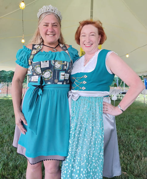 Two women in teal german dirndls add an event in Bavaria. Great outfit for an bavarian event 