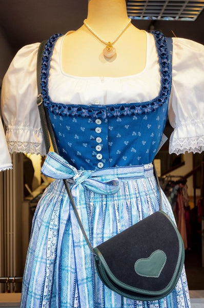 Blue german Dirndl dress with white cotton blouse, commonly worn in the alpine regions 