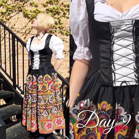 day 9 dirndl challenge girl standing at a stairwell in a dirndl vest with a middle eastern embroidered skirt