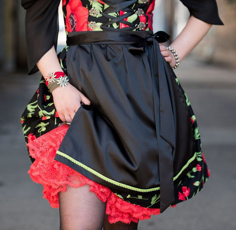 image of a poppy print dirndl with black apron and red petticoat