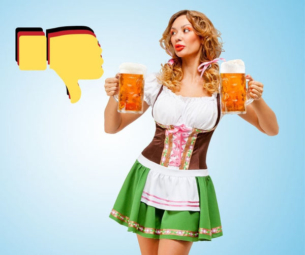 woman in costume dirndl holding a beer