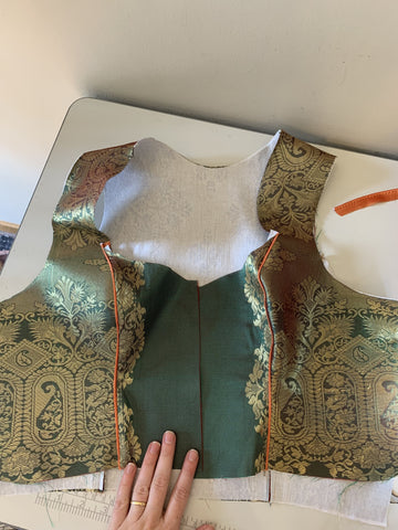 oktoberfest dress bodice during the sewing process laid out on a sewing table. custom dirndl designed using sari fabric