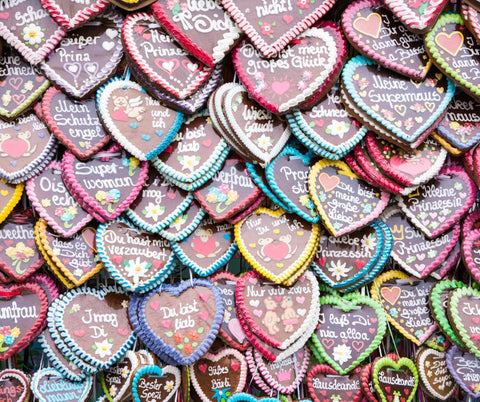 a wall covered in german gingerbread decorated heart cookies at oktoberfest