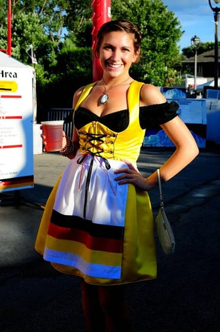 Woman in yellow dirndl with black blouse