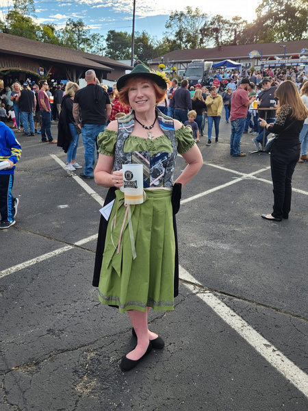 Woman wearing a Taurus Zodiac dirndl dress at an oktoberfest celebration - Dirndls for special occasions