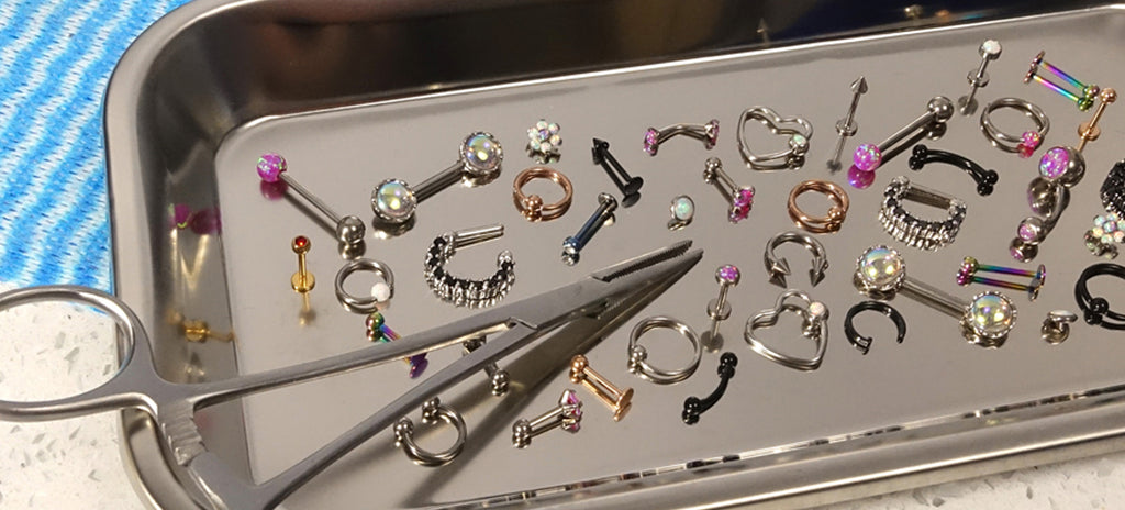 A surgical steel tray showcasing nose piercing jewellery that is clean and hygienic.