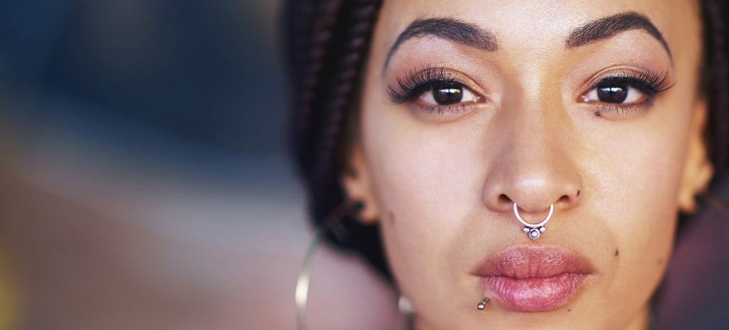 A women showing her fashionable septum ring piercing.