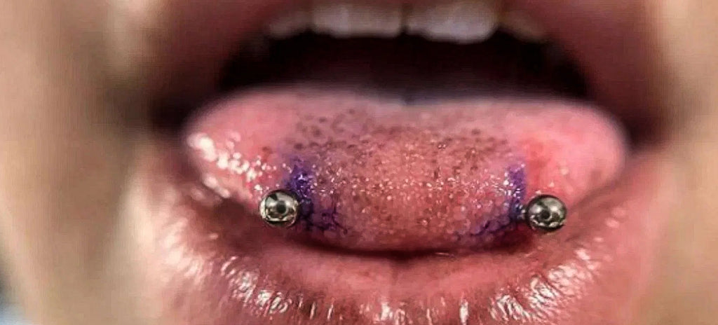 A women showing her new snake bite piercings, which will take time to heal.