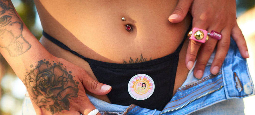 A women showing her fashionable belly ring in the summer after pregnancy.