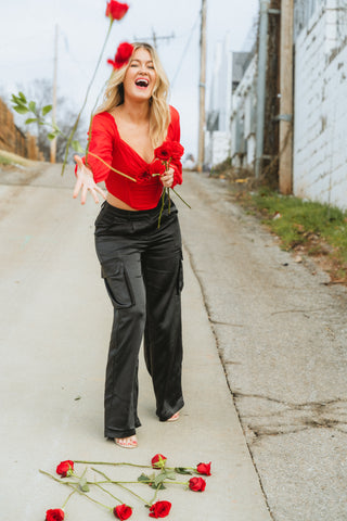 Red corset top paired with black satin cargo pants from Lush Fashion Lounge boutique in Oklahoma City