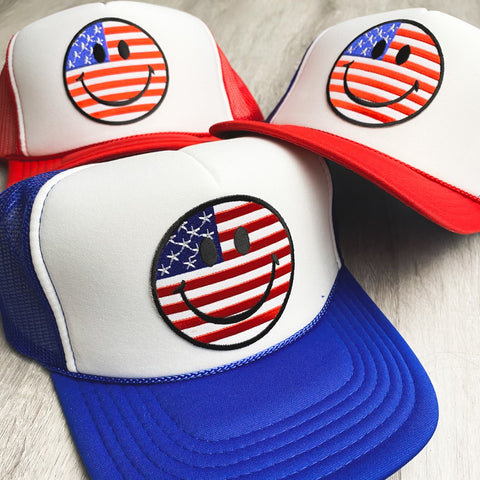 4th of July smiley face trucker hats from Lush Fashion Lounge women's boutique in Oklahoma City