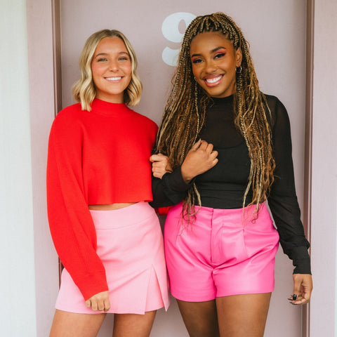 Pink shorts with red sweater and black mesh bodysuit on 2 models from Lush boutique in Oklahoma