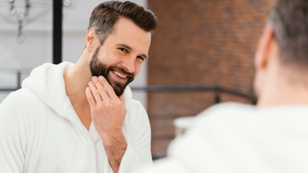 Homem arrumando a barba no espelho