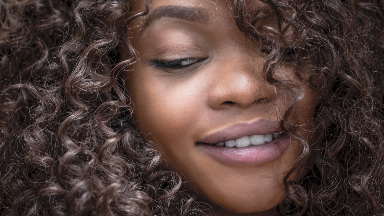 Mulher negra com cabelo cacheado