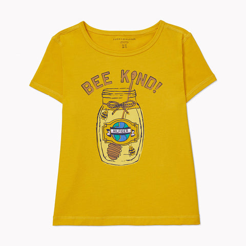 Alt text: A yellow Tommy Hilfiger Anna Fashion Tee with ‘Bee Kind’ text above a drawn honeypot. Tee shown on off-white background.