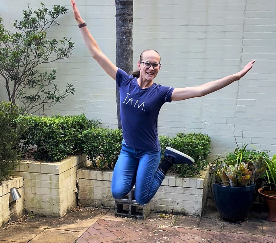 Tamsin, a young Paralympic athlete star jumps wearing navy Billy Footwear sneakers from EveryHuman.