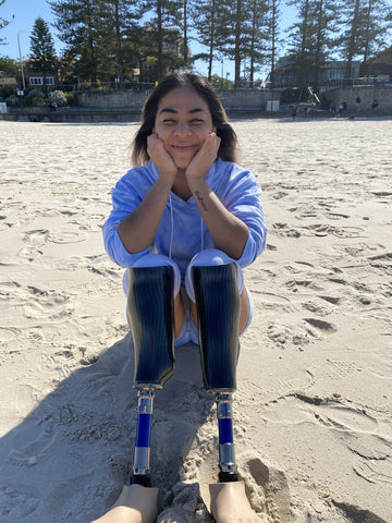 Juttima, a young amputee poses at the beach. 