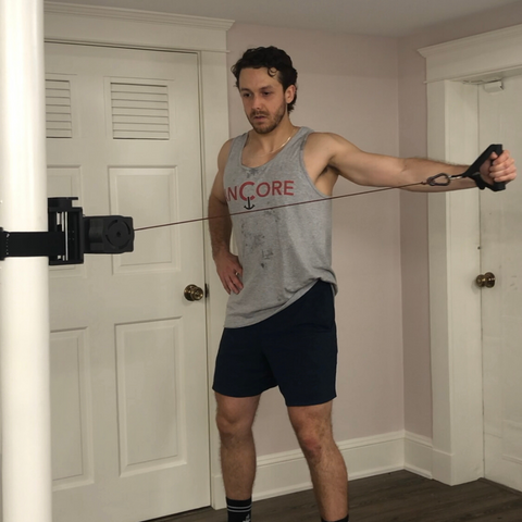 athlete doing a shoulder circuit indoors on the ancore trainer