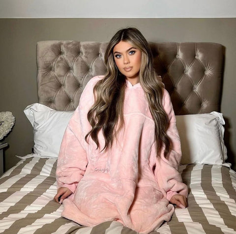 Belle Hassan wearing pink hooded blanket