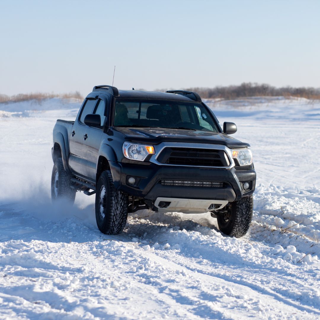 Toyota Truck driving through snow