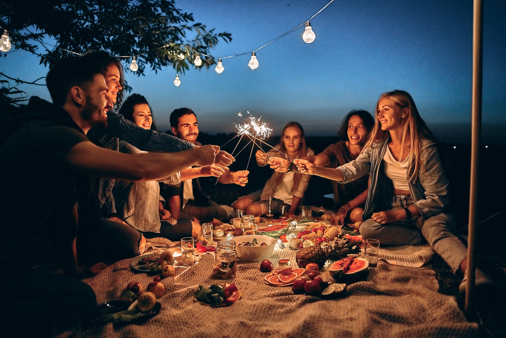 friends enjoying picnic at night.