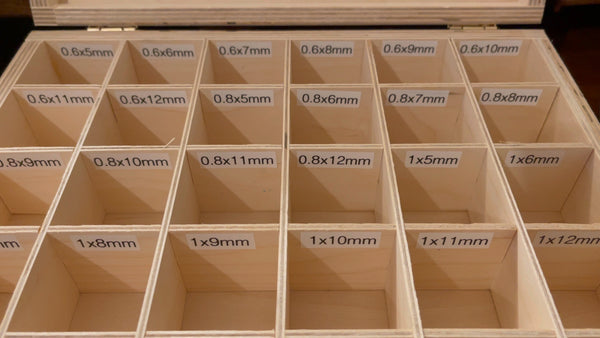 Close-up of a labeled jewelry stock box organized by ring sizes