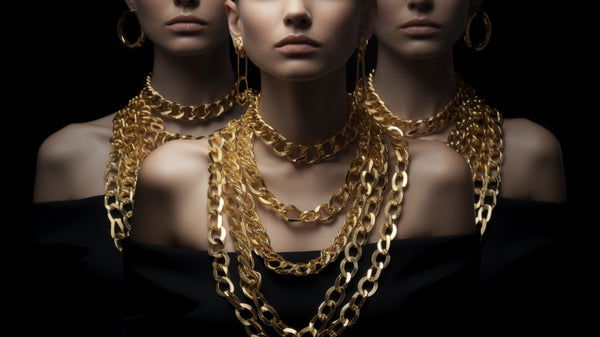 Models showcasing chunky gold necklace chains from Roberts & Co's collection, exemplifying bold elegance.