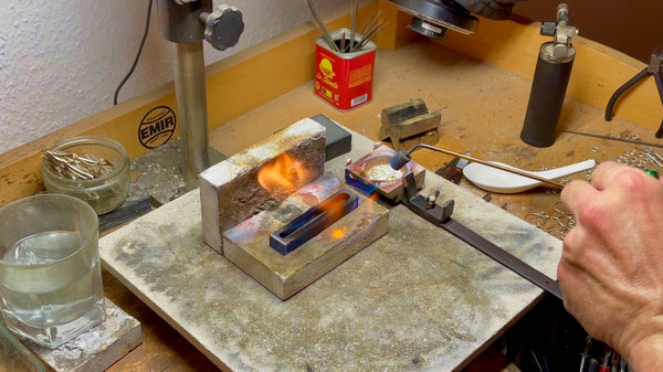 The initial stages of heating a graphite ingot mold, preparing it for the casting process.
