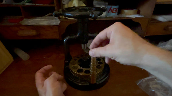 Demonstration of fitting the brass dies onto the machine's die holder