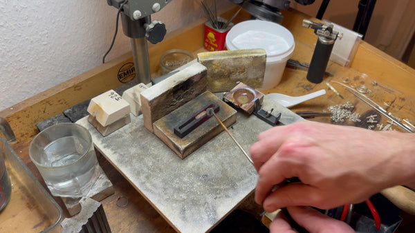 Gold ingot undergoing the annealing process, rekindled flame enhancing strength