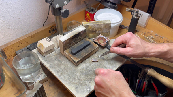 Gold ingot cooling in mold, transitioning from liquid to solid