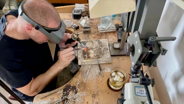 Soldering process of T-bar pendants showcasing craftsmanship.