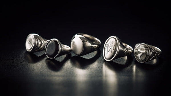 Array of silver signet rings showing different engraving styles